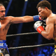 Keith Thurman (left) uses his length to connect with Shawn Porter. (Photo credit: Ed Mullholland/Getty)
